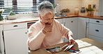 Smile, laughing and photograph nostalgia with an old woman in the kitchen of her retirement home. Funny, memory and past with a happy senior person looking at pictures to relax alone in her house