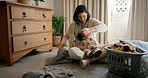 Family, laundry or cleaning with a mother and son in a bedroom of their home together for housekeeping. Kids, help and housework with an asian woman teaching her boy child about hygiene or chores