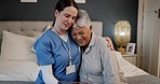 Comfort, hugging and nurse with senior woman in the bedroom for medical wellness consultation. Happy, care and caregiver embracing an elderly patient in retirement on bed for support at nursing home.