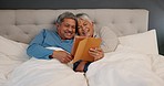 Tablet, love and senior couple in a bed laughing at comic, video or social media video at home. Digital, comedy and retired people in a bedroom with streaming subscription or funny, movies or film