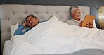 Couple, divorce and senior man ignore woman in a bed after fighting, crisis or dispute at home. Bedroom, conflict and old male with depression, rejection or bad mood from cheating wife on tablet