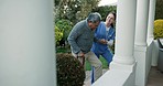 Walking, senior man and caregiver helping patient up stairs, steps and elderly care for client on nursing home staircase. Cane support, medical nurse service and woman aid old person with disability