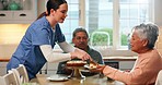 Cake, nurse and assisted living with an old couple together in the kitchen of a retirement home. Senior man, woman and caregiver cutting dessert in a house for happy celebration or milestone event