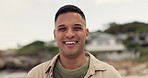 Travel, happy and portrait of man at beach to relax on vacation or holiday destination for summer break. Happiness, freedom and confident young person by the sea or ocean for trip with smile