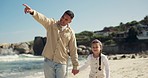 Beach walk, pointing and happy family holding hands with child, bonding and papa gesture at destination, holiday or view. Ocean sand, father love and kid with dad care, support and travel on vacation