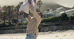 Dad, beach fun and playing with child in air with bonding, travel and holiday in Miami outdoor. Love, father and young girl with happy family and vacation on trip by the sea and ocean with kid