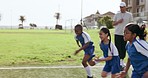 Fitness, sports or race and kids running on a field together for training or competition with a coach. Exercise, sprint and speed with a group of student children on grass for physical education