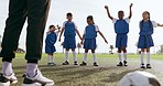 Children, arm warm up and sport on soccer field with coach for training and school fitness. Youth, kids and workout for competition in uniform with girl and athlete group with students and exercise