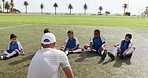 Children, leg stretching and sport on soccer field with coach for training and school fitness. Youth, kids and workout for competition in uniform with game and athlete group with student and exercise