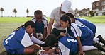 Teamwork, clipboard and children on field for soccer prepare for game, match and practice outdoors. Sports, coaching and young kids huddle for training schedule, exercise and planning for tournament