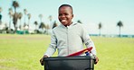 Happy black child, bin and recycling in nature for community service, volunteering or saving environment. African little boy smile carrying recycle plastics, garbage or waste for earth day cleaning