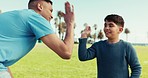 High five, recycling and a man with a boy child outdoor on a field together for eco friendly support. Motivation, volunteer and a father with his son for community service or climate change awareness