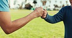 Fist bump, greeting of father and kid for love, trust and solidarity outdoor at park. Hands together, closeup of dad and child meeting for family support, healthy relationship or connection in nature