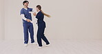 Couple, happy and nurse dancing together in hospital for healthcare, wellness and love. Smile, man and woman moving with energy to music, celebration and mockup space in medical professional clinic