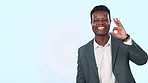 Hand pointing, face and business man with perfect sign in studio for checklist, info or sign up on blue background. Happy, portrait and African male entrepreneur show presentation, offer or success