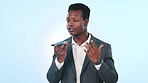 Voice note, record and business black man in studio with phone for speaker call, talking and conversation. Communication, smartphone and person for contact, speaking and networking on blue background