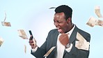 Business phone, money rain celebration and black man reading win announcement, investment income or financial deal. Studio cellphone, winner notification or agent celebrate revenue on blue background