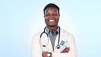 Happy, black man and doctor with arms crossed in studio for healthcare, pride and smile on blue background. Hospital, portrait and African male surgeon with expert, friendly and consulting services