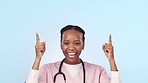 Happy black woman, doctor and pointing up in advertising or marketing against a studio background. Portrait of African female person or nurse smile and showing notification, alert or deal on mockup