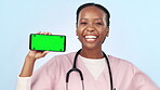 Doctor, smile and phone with green screen, ok and pointing to smartphone for advertising. Happy black woman, marketing a medical promotion for commercial, hospital app and promotion in wellness