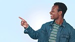 Smile, pointing and black man in studio with mockup space for marketing, promotion or advertising. Happy, excited and portrait of young African model with show gesture isolated by white background.