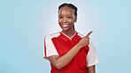 Soccer, black woman point and studio sports info, fitness commercial or mockup athlete promo, advertising or logo space. Workout portrait, palm gesture and African football player on blue background