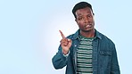 Face, hand pointing and black man with no vote in studio for feedback, results or review on blue background. Reject, portrait and frustrated African male model with stop emoji, warning or mistake 