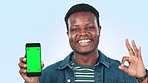 Black man, phone green screen and okay hands for success, student marketing and information in studio. Face of young person with mobile mockup, college application or registration on blue background