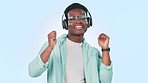 Music, dance and face of black man in studio for streaming song, radio and audio on blue background. Happy, freedom and portrait of person listening to track, dance and move for energy, fun and relax
