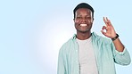 Smile, ok sign and black man pointing at checklist, timeline and info on mockup space. Portrait, okay hand and person show advertising, marketing presentation and review isolated on a blue background