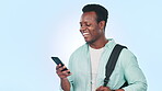 Man, student and phone with backpack for education chat, social media and funny, e learning communication. Happy African person with mobile for university, travel or news on a blue, studio background