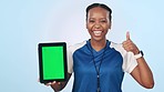 Happy black woman, tablet and green screen with thumbs up for sports app against a studio background. Portrait of African person or athlete with technology display, like emoji or yes sign on mockup