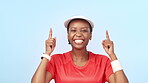 Tennis, pointing and excited black woman in celebration of winning in fitness isolated in a studio blue background. Victory, promotion and portrait of athlete with opportunity to workout in giveaway