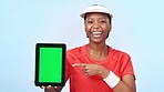 Woman, pointing and tablet with green screen for social media with mockup in studio, blue and backdrop with chromakey. African, person and happiness with app, online or digital marketing for offer