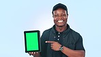 Happy black man, tablet and pointing to green screen in advertising or marketing against a studio background. Portrait of African male person smile showing technology display, app or mockup space