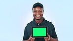 Tablet mockup, green screen and black man with advertising for delivery service, courier app and ads on blue background. Tracking marker, social media promo and marketing for shipping in studio