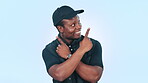 Choice, pointing and black man with decision on information for deal, sale or giveaway isolated in studio blue background. Smile, happy and person showing option or notification in presentation