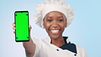 Chef, phone and woman with green screen or mockup with food blog, social media or show online recipe. Cooking, mobile app and portrait with restaurant menu promo and hand on blue background in studio