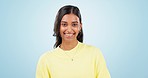 Happy, woman and face in studio with fashion, trendy style and clothes with blue background. Smile, confidence and female person from India with a model portrait and modern clothing with skin glow