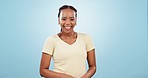 Face, happy black woman and laugh in studio with confidence, joke and good mood on blue background. Portrait, young model and smile with carefree personality for comedy, expression and funny reaction