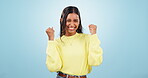 Happy, excited woman and face in studio with celebration from achievement with blue background. Smile, success and female person from India with winner, cheer and good news of promotion or winning