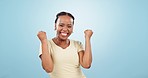 Woman, dance and success with fist in studio to celebrate deal, promotion or winning lotto prize on blue background. Portrait of excited african model, winner and yes for bonus, competition or reward