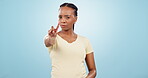 Woman, shake head and finger with warning in disagree meme, authority and blue studio background. African person, gen z style and portrait for awareness to stop, negative outcomes with bad choices