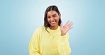 Wave, greeting and woman face with a smile and communication in a studio. Happy, excited and hello hand sign with welcome, thank you and portrait with a female person from India with blue background
