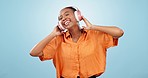 Dance, black woman and music headphones in studio for celebration of freedom, party and hearing audio song on blue background. Happy model listening to multimedia, disco sound and radio subscription