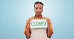 Black woman, closed sign and advertising in marketing, mistake or bankruptcy against a blue studio background. Portrait of African female person with billboard or poster for out of service or fail