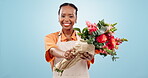 Happy, florist and black woman with gift of flowers in studio isolated on a blue background mockup. Portrait, bouquet and giving floral present, roses or plants in small business shop of entrepreneur