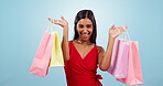 Happy dance, woman or shopping bag in studio for retail deal, winner or financial freedom on blue background. Portrait of excited indian customer celebrate with gift bags, discount or sales promotion