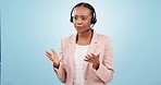Callcenter, communication and help desk, black woman and phone call with telecom or customer service on blue background. Contact us, CRM and talking for telemarketing sales and consultant in a studio