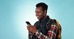 Phone, search and black man with backpack in studio for travel, hiking or text on blue background. Smartphone, app and happy African guy traveler with location, map or social media gif communication